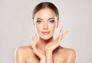 Beautiful Young Woman with Clean Fresh Skin after aesthetic plastic surgery