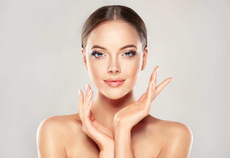 Beautiful Young Woman with Clean Fresh Skin after aesthetic plastic surgery