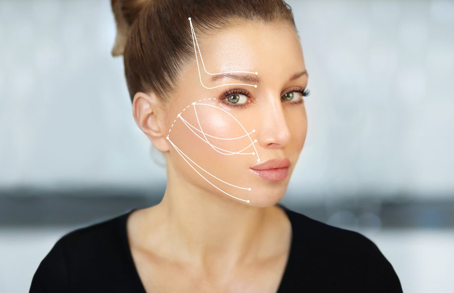 women face with facelift pre-marking on face